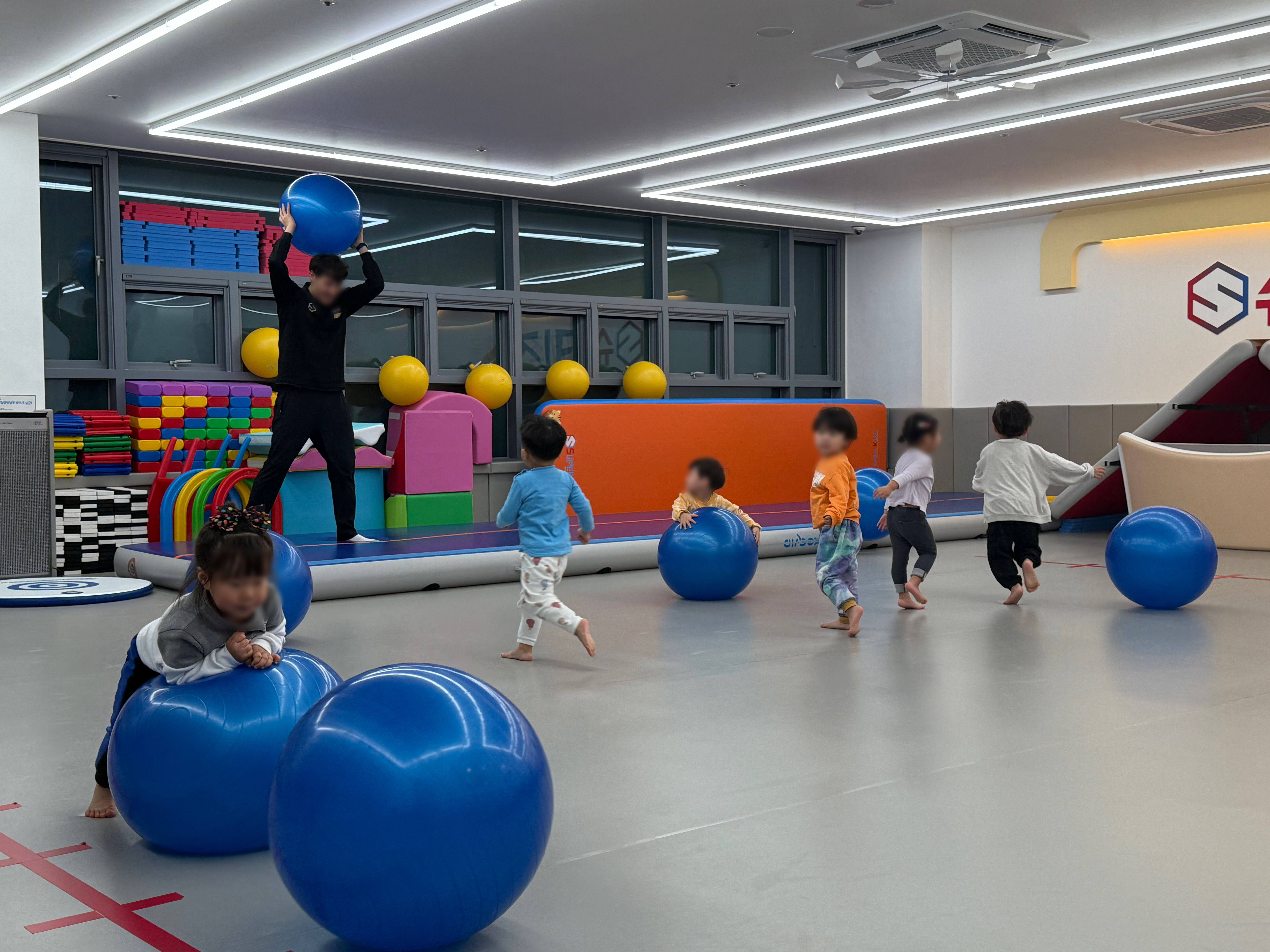 Coach guiding children through an active GYM movement session